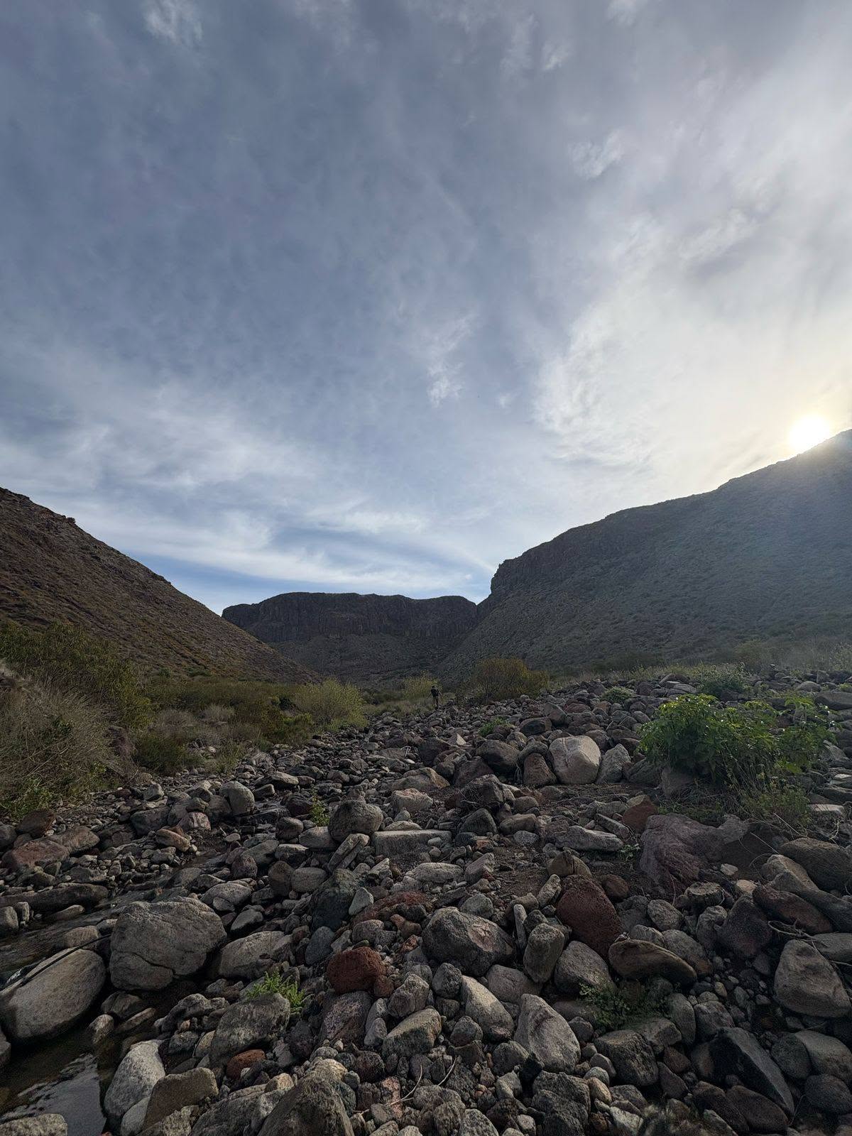 Arroyo de piedras al amanecer entre los cerros